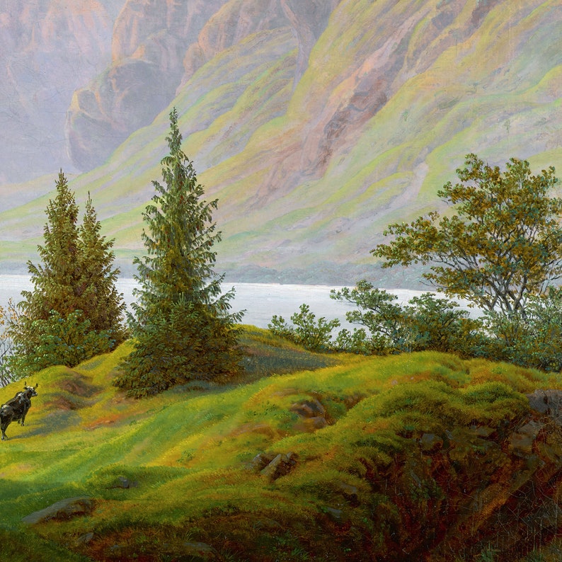 May include: A painting of a mountain landscape with a lake in the foreground. The lake is surrounded by green hills and trees. A single cow is standing in the grass near the water's edge.