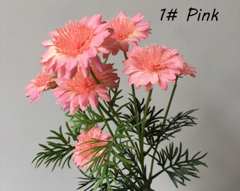May include: A bouquet of pink artificial flowers with green leaves. The flowers are similar to daisies and have a delicate, layered appearance. The text "1# Pink" is visible in the upper right corner of the image.