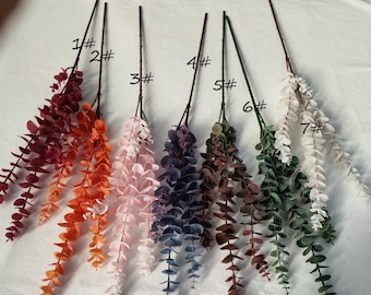 May include: Seven artificial eucalyptus stems in different colors, including burgundy, orange, pink, purple, brown, green, and white. The stems are labeled with numbers 1 through 7.