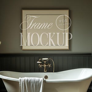 May include: A white bathtub with gold fixtures in a bathroom with dark green walls and a framed picture above the tub. The picture frame is gold with a white mat and a beige background. The text "Frame Mockup" is written in white on the picture.