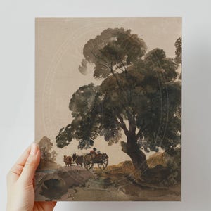 May include: A watercolour painting depicting a rural scene with a large tree in the foreground. Two horses are pulling a cart with a person sitting inside. The painting is rendered in shades of brown and green.