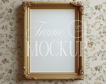 May include: A gold ornate picture frame with a white background. The frame is on a floral wallpaper background.