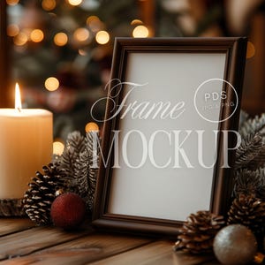 Christmas Frame Mockup 2x3 Ratio PSD Cozy Holiday Decor Art Print Display on Wooden Table with Candlelight & Pine Cones for Festive Wall Art