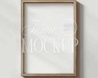 May include: A light wood frame mockup with a white background. The frame is empty and ready for your design.