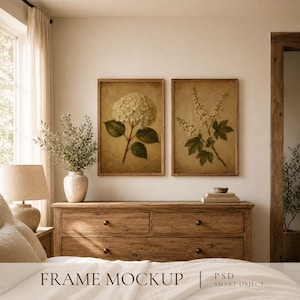 May include: Two rectangular wooden frames containing botanical prints of white flowers on a textured beige background, displayed above a wooden dresser. The text "FRAME MOCKUP | PSD SMART OBJECT" is visible at the bottom of the image.