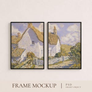 May include: Two vertical rectangular wall art prints in thin black frames, each displaying an impressionist painting of a white cottage with a thatched roof, stone walls, and green foliage under a light purple sky with clouds. Text reads PSD SMART OBJECT.