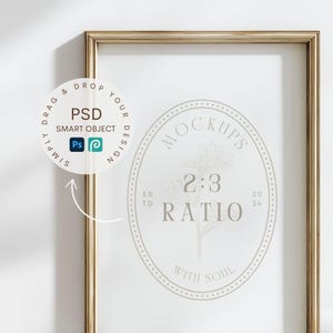 May include: A gold-colored rectangular picture frame with a white interior. The frame contains a circular graphic with the text "MOCKUPS 2:3 RATIO WITH SOUL". A circular graphic with the text "PSD SMART OBJECT" is in the upper left corner.