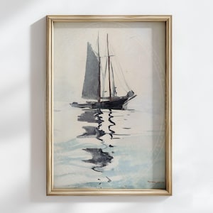 May include: Watercolor painting of a sailboat on the water, framed in a gold-colored frame. The sailboat has a dark gray sail and is reflected in the water. The artwork has a vintage aesthetic.