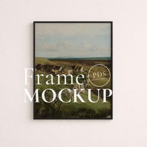 May include: A framed landscape painting depicting a village in a valley, under a cloudy sky. The artwork is in a black frame, with the words "Frame MOCKUP" in white text. A circular logo with the text "PDS SMART OBJECT" is also visible.