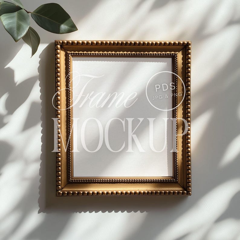 a picture frame sitting on top of a wall next to a plant