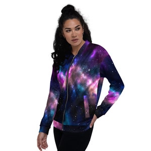 May include: A purple, blue, and black bomber jacket with a galaxy print. The jacket has a zipper closure and two pockets.
