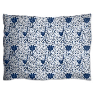 May include: A white pillowcase with a blue floral pattern featuring repeating stylized tulips and leaves.