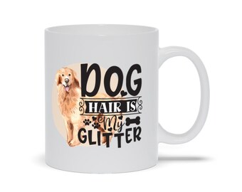 May include: White ceramic mug featuring a golden retriever illustration and the text "DOG HAIR IS MY GLITTER". The design includes paw prints and a bone graphic. The mug has a curved handle.