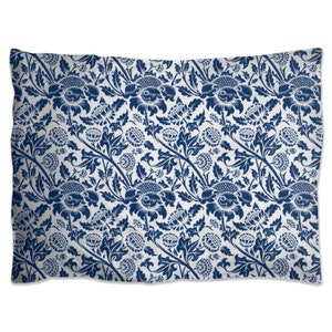 May include: A blue and white pillowcase with a floral pattern. The pattern features stylized flowers and leaves.