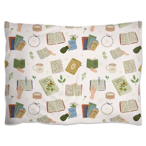 May include: A white pillowcase with a repeating pattern of books, candles, flowers, and other objects. The pattern is in shades of green, brown, yellow, and blue.