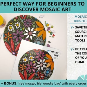 finished mosaic art kit with floral design with metal tweezers, bottle of wood glue and some extra tiles around the mosaic, instructions sheet with large color image is placed on top of the mosaic.