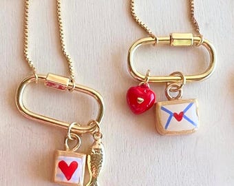 Curated Carabiner Necklace with a dainty, handmade charm paired with tiny various gold filled charms.