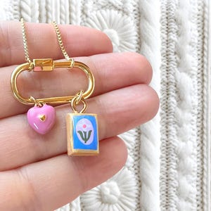 Curated Carabiner Necklace with a dainty, handmade charm paired with tiny various gold filled charms.