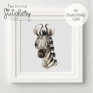 May include: A black and white cross stitch pattern of a cute zebra with big eyes. The pattern is framed in a white frame and has the text "THE LITTLE Stitchery LITTLE TREATS FOR YOU TO SEW & LOVE" at the top. The text "PDF DOWNLOADABLE CHART" is in the top right corner.