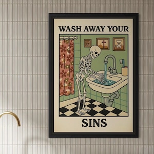 May include: Black framed poster featuring a retro illustration of a skeleton washing its hands in a sink. The text "WASH AWAY YOUR SINS" is at the top and bottom. The background includes a floral shower curtain and a checkered floor.