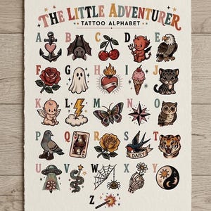 May include: A rectangular art print titled The Little Adventurer Tattoo Alphabet featuring twenty-six letters of the alphabet, each paired with a colorful, traditional-style tattoo illustration, including an anchor, bat, cherry, devil, and tiger.