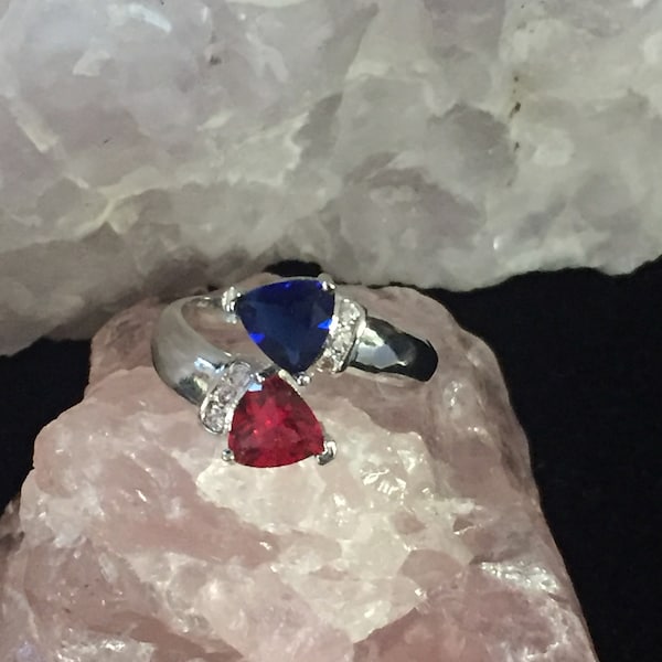 Sapphire and Ruby silverplated ring with wht zircons on sides 10.00