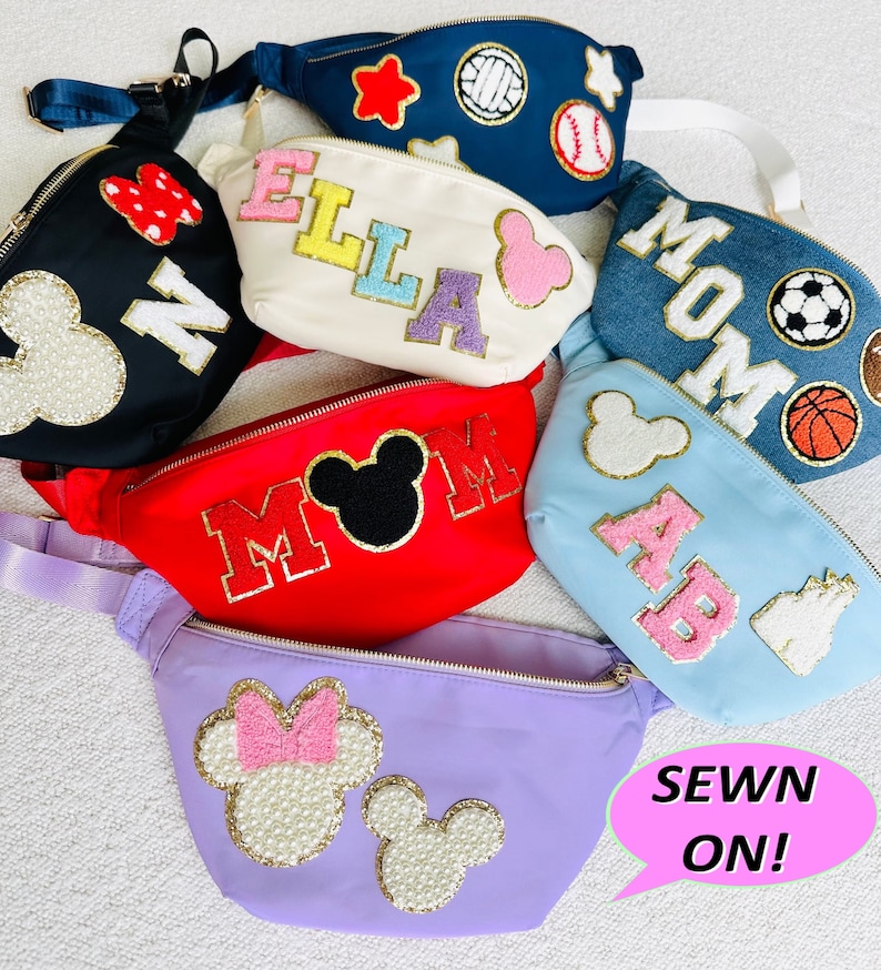 May include: Six colorful fanny packs with various embroidered designs, including Mickey Mouse, sports, and names. The text "SEWN ON!" is in a speech bubble.