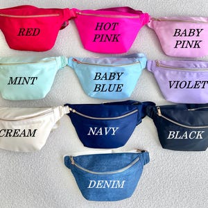 May include: Nine different colors of fanny packs with gold zippers. The colors are red, hot pink, baby pink, mint, baby blue, violet, cream, navy, and denim.