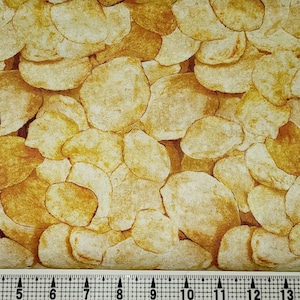 May include: A fabric with a pattern of overlapping, light brown and beige, irregularly shaped, organic forms that resemble potato chips.