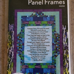 May include: A quilting pattern for a framed artwork featuring the lyrics to the hymn "Amazing Grace". The pattern includes three framing layouts and is designed to be used with fabric from the "How Sweet The Sound" collection by QT Fabrics. The image shows a colorful stained glass style design with a purple, blue, and green color scheme.