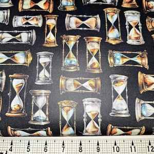 May include: A black fabric with a repeating pattern of gold and silver hourglass shapes. The hourglasses are in various positions and have a vintage look.