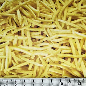 May include: A close-up image of a fabric with a pattern of yellow french fries. The fabric is textured and looks like it could be used for a craft project.