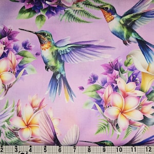 May include: A fabric featuring a repeating pattern of hummingbirds, flowers, and foliage. The hummingbirds have iridescent blue, green, and orange feathers. The flowers are white, yellow, and pink, set against a lilac background.