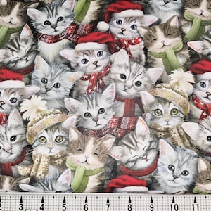 May include: A fabric print featuring numerous adorable kittens. The kittens are depicted with gray and brown tabby markings, wearing festive accessories like red Santa hats, scarves, and winter hats. The overall design is a repeating pattern.