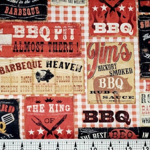 May include: A red and white gingham fabric with a variety of vintage-style signs featuring barbecue-themed text and graphics. The signs include phrases like "Barbeque Heaven", "Jim's Hickory Smoked BBQ", and "The Best Beef Brisket in the South".