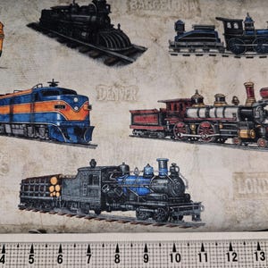 May include: Fabric with various train illustrations in shades of blue, red, yellow, and black. The fabric has a vintage look with city names like Denver and London printed on it. A ruler is at the bottom.