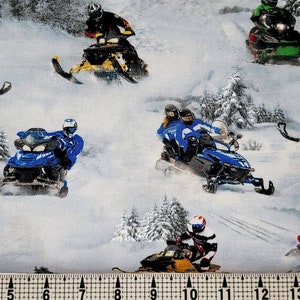 May include: A white fabric with a repeating pattern of snowmobiles on a snowy background. The snowmobiles are in various colors, including red, blue, green, and yellow. The snowmobiles are all in motion, with riders in helmets and winter gear.
