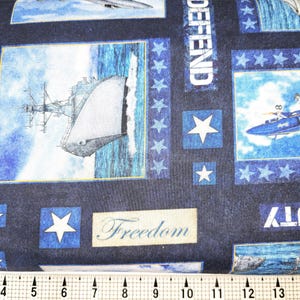 May include: Blue and white fabric with a navy blue background. The fabric features a repeating pattern of stars, ships, airplanes, and the words "DEFEND", "DUTY", and "Freedom".