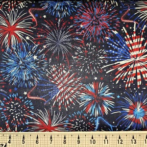 May include: Red, white, and blue fireworks on a black background. The fabric is perfect for crafting projects, quilting, and home decor.