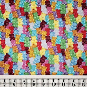 May include: A colorful fabric with a repeating pattern of gummy bears in various colors, including red, orange, yellow, green, blue, purple, and brown.