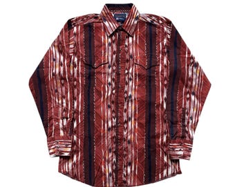 May include: A long-sleeved button-down shirt with a vertical striped pattern in burgundy, white, and navy blue. The shirt features two chest pockets and a classic collar. The fabric appears to be woven.