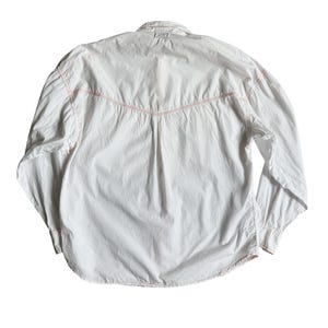 May include: A white long-sleeved button-down shirt featuring a pointed western-style back yoke with contrasting orange stitching along the seams. The shirt has a standard collar, long sleeves with buttoned cuffs, and a slightly curved hemline.