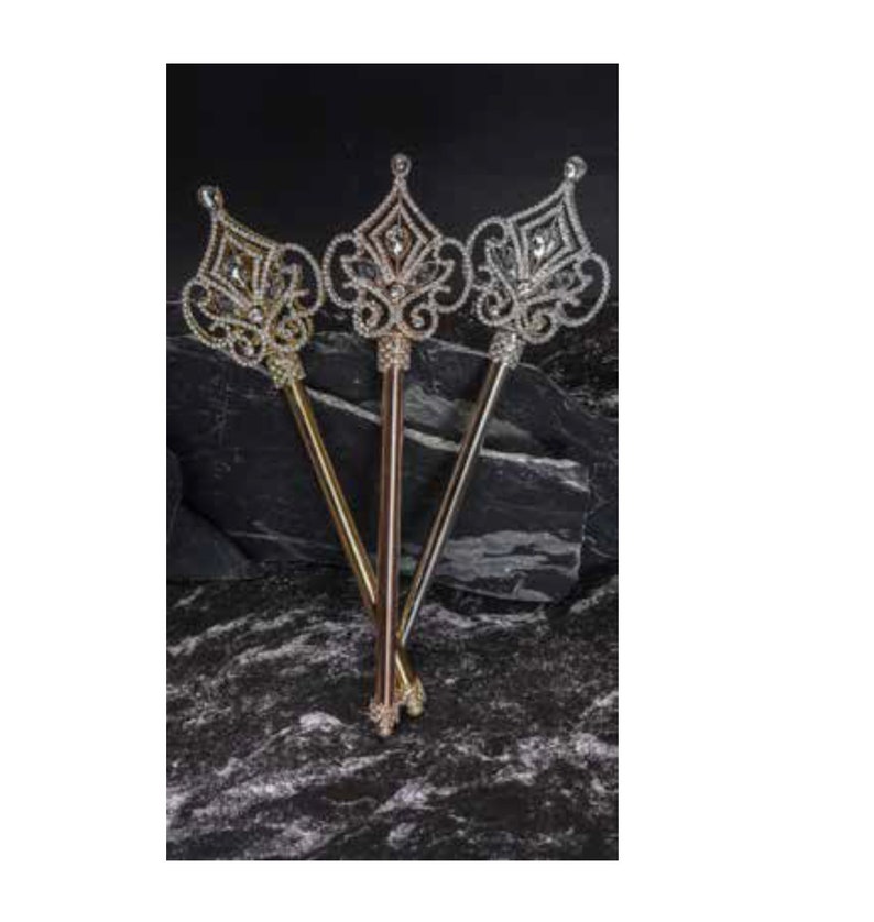 May include: Three ornate jeweled scepters with gold, silver, and rose gold finishes. The scepters have a crown-like top with intricate details and are made of plastic.