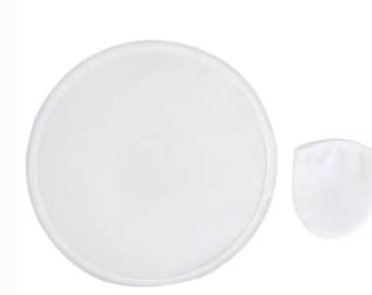 May include: A white, circular, mesh-like object with a rounded edge, next to a smaller, white, pouch-shaped item. Both items are set against a plain white background. The objects appear to be made of a soft, pliable material.