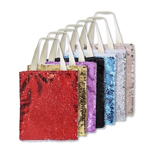May include: A collection of sequined tote bags in various colors, including red, gold, purple, black, blue, silver, and tan. Each bag has a rectangular shape, cream-colored handles, and a shimmering, textured surface.