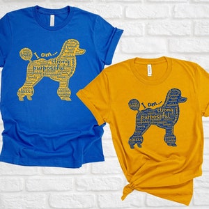 May include: Two t-shirts with a poodle silhouette made of words. The blue shirt has a yellow poodle with the words "I am... strong, purposeful, capable, brave, classy" and the yellow shirt has a blue poodle with the words "I am... strong, purposeful, capable, brave, classy".