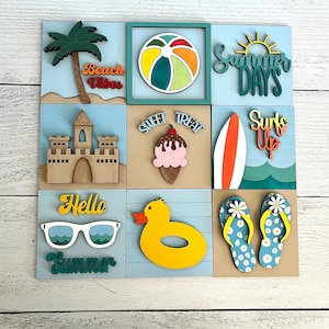 May include: A wooden summer-themed wall art piece with nine square panels. Each panel features a different beach-related design, including a palm tree, beach ball, sandcastle, ice cream cone, surfboard, sunglasses, duck, and flip-flops. Text includes "Beach Vibes", "Summer Days", "Sweet Treat", "Surf's Up", "Hello Summer".