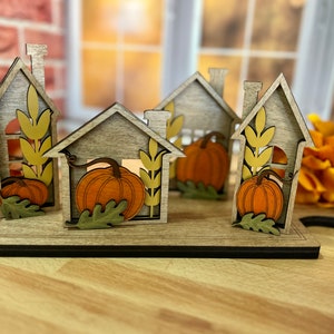 Fall harvest mini house collection with faux cutting board display, pumpkins, fall leaves autumn decor, centerpiece, table decoration