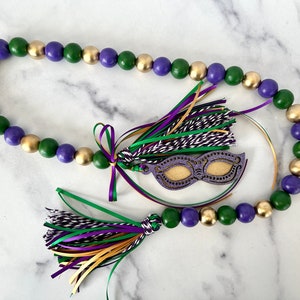 Mardi Gras wood bead garland, purple, green, gold with mask tag and colorful ribbons