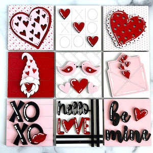 May include: Nine wooden Valentine's Day signs with various designs. The signs feature hearts, birds, gnomes, and the words "XO XO", "hello love", and "be mine".